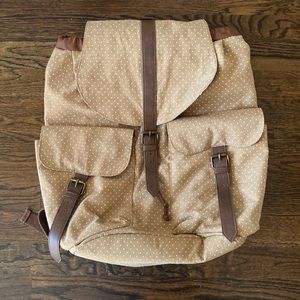 Tan with white polka dot backpack.